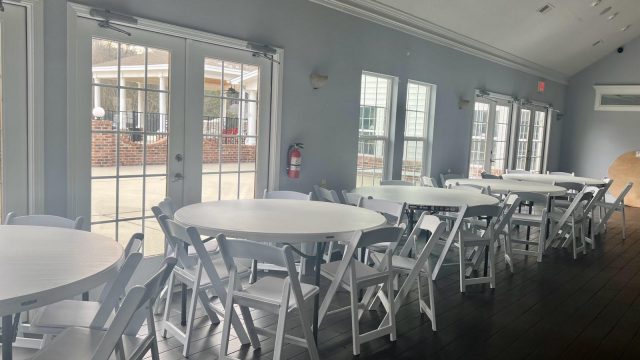 White resin chairs and round tables